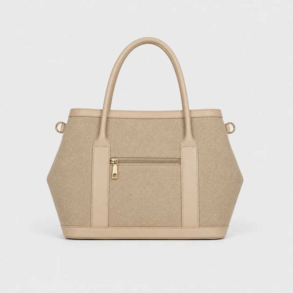 A structured beige tote bag with dual top handles, a front zippered pocket, and gold-tone hardware, shown against a plain light gray background.