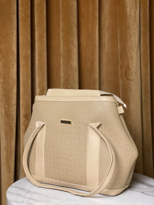 Beige handbag with textured pattern on canvas