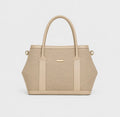 A structured beige handbag with a textured woven body, smooth beige leather trim, dual top handles, and small gold-tone hardware, shown on a clean light gray background.