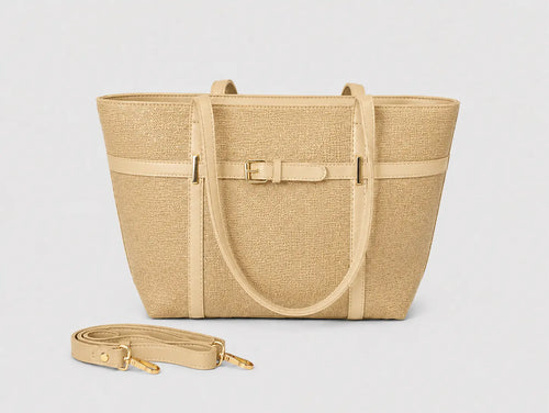 A structured tote bag in a woven beige material with light beige trim, featuring a central buckle strap detail and a detachable shoulder strap placed in front, set against a plain light gray background.