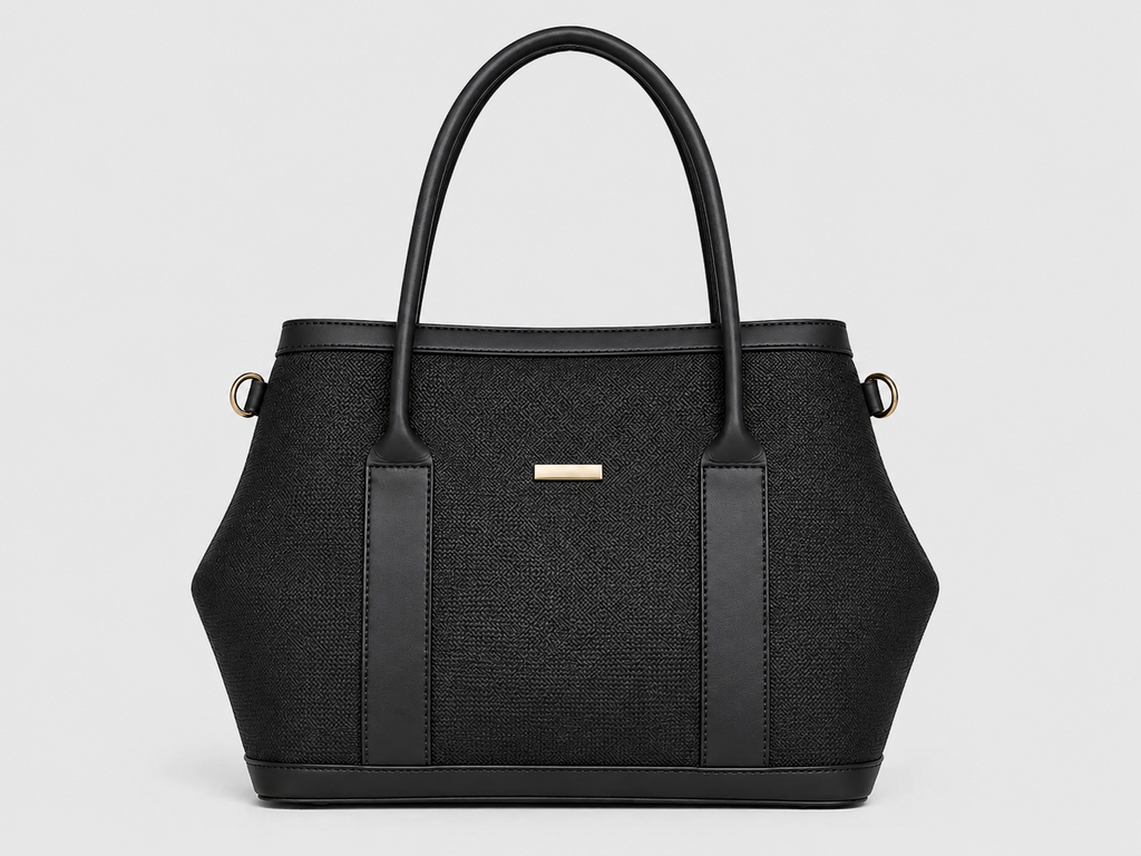 A structured black handbag with a woven texture, dual top handles, vertical leather side panels, and a small gold-tone rectangular logo plaque on the front, shown against a light gray background.