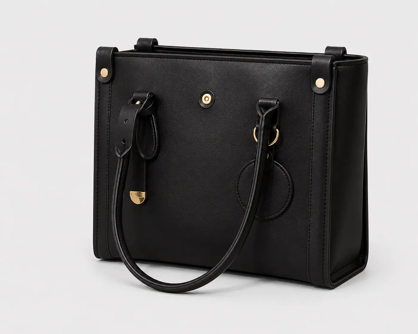 A black leather handbag with gold-tone hardware, featuring a structured rectangular body, top handle, and shoulder strap, photographed on a light gray background.