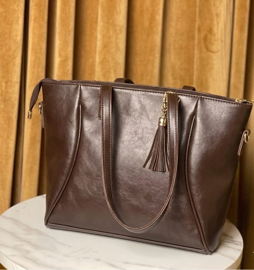 Brown leather handbag with a tassel