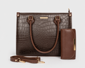 A dark brown crocodile-embossed handbag set with a matching zip-around wallet and detachable shoulder strap, displayed on a light gray background.