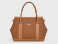 A structured tan tote bag with a woven brown body, smooth tan leather trim, dual top handles, and a small gold-tone logo plaque on the front, shown against a light gray background.