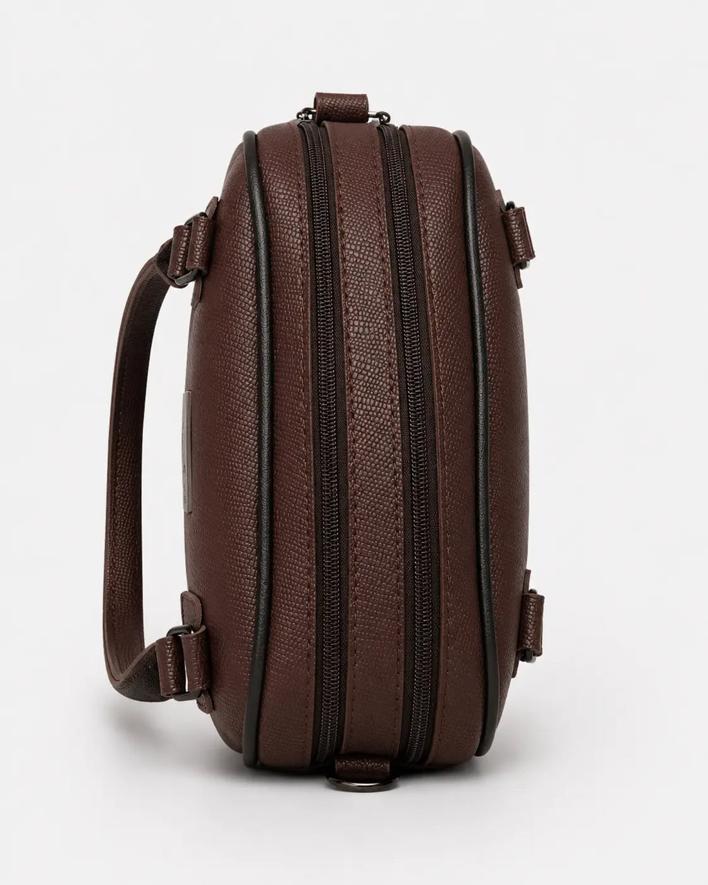 A dark brown textured leather crossbody bag with dual vertical zippers and a single shoulder strap, shown against a plain light gray background.