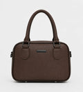 A dark brown textured leather handbag with double top handles, a small rectangular metal plaque on the front, and side hardware, shown against a plain light gray background.