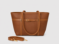 A structured brown faux-leather tote bag with a matching detachable shoulder strap, displayed on a light gray background.