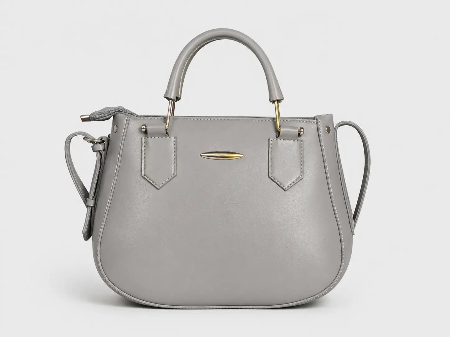 A light gray leather handbag with a top handle, shoulder strap, and gold-tone hardware, shown against a plain light gray background.