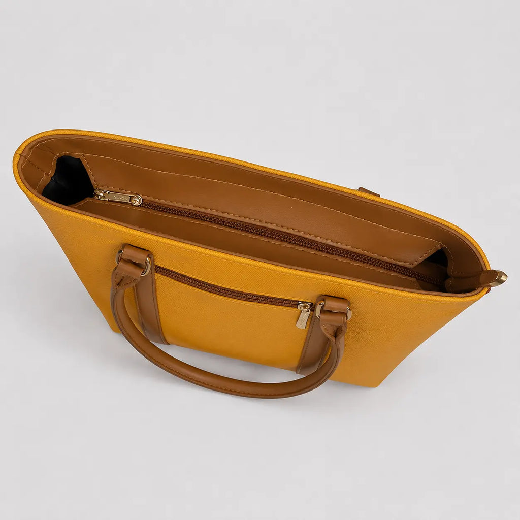 A mustard yellow tote bag with brown handles and trim, shown from an overhead angle on a light gray background.
