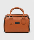 A structured brown pebbled leather handbag with top handles, silver-tone hardware, and a black brand plaque on the front, photographed against a light gray background.
