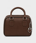 A brown textured leather handbag with a top handle, silver-tone hardware, and a dangling heart-shaped padlock charm on a chain, shown against a plain light gray background.