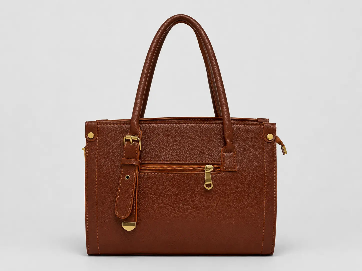 A brown textured leather handbag with double top handles, a front zippered pocket, and gold-tone hardware, shown against a light gray background.