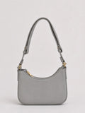 A light gray leather shoulder bag with a curved top, gold-tone hardware, and a matching adjustable shoulder strap, shown against a plain light gray background.