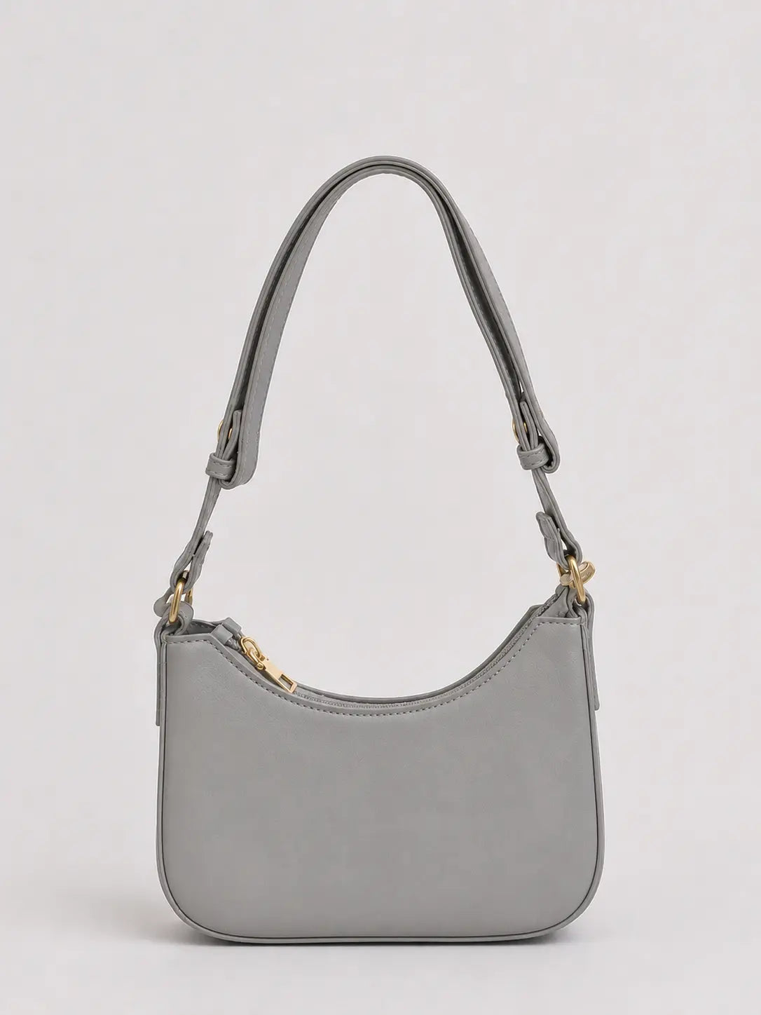 A light gray leather shoulder bag with a curved top, gold-tone hardware, and a matching adjustable shoulder strap, shown against a plain light gray background.