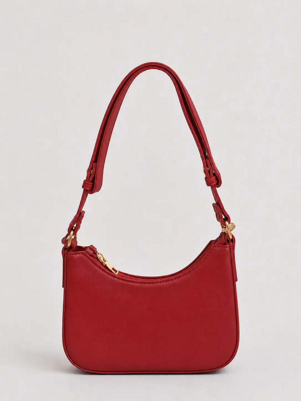 A red leather shoulder bag with a curved top, gold-tone hardware, and a matching red strap, shown against a light gray background.